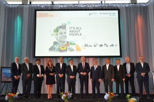Image showing the Honored guests attending the European Kubota Headquarters opening ceremony on stage in front of a screen.