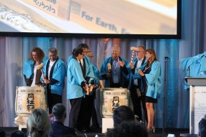 Honored guest cracking open a sake barrel on stage